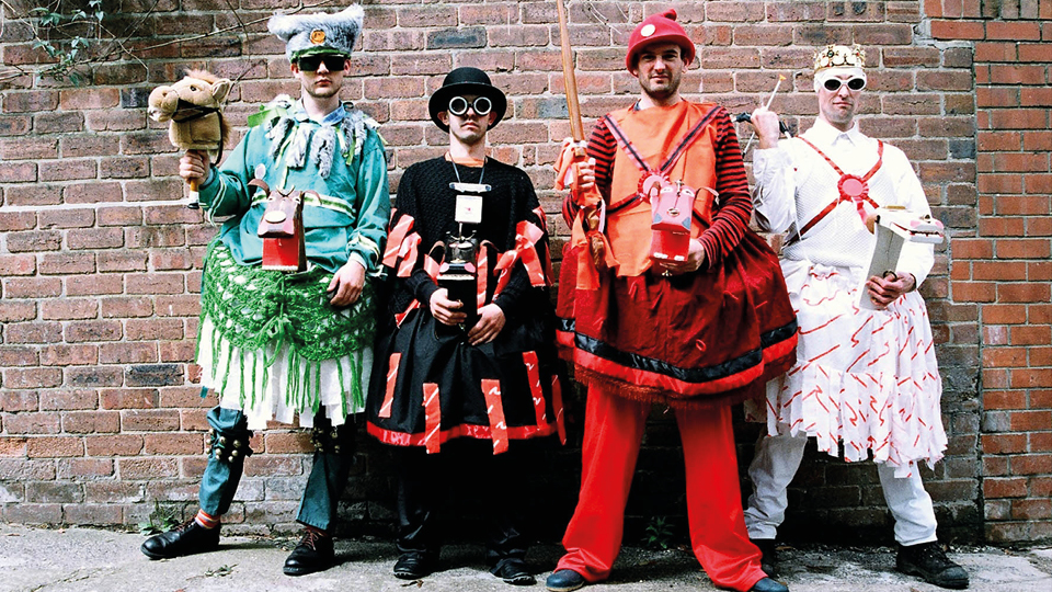 Four men in eccentric and colourful morris costumes