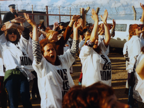A group of people singing together at a protest.