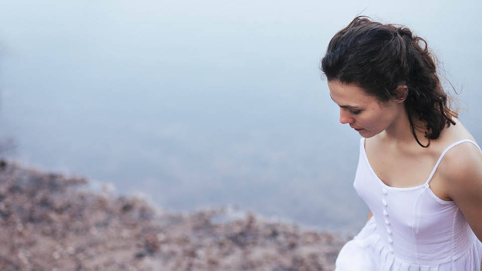 a woman with long hair in a white dress