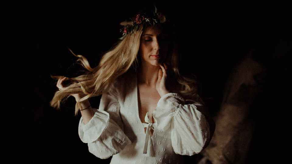 a woman with long hair in a white dress