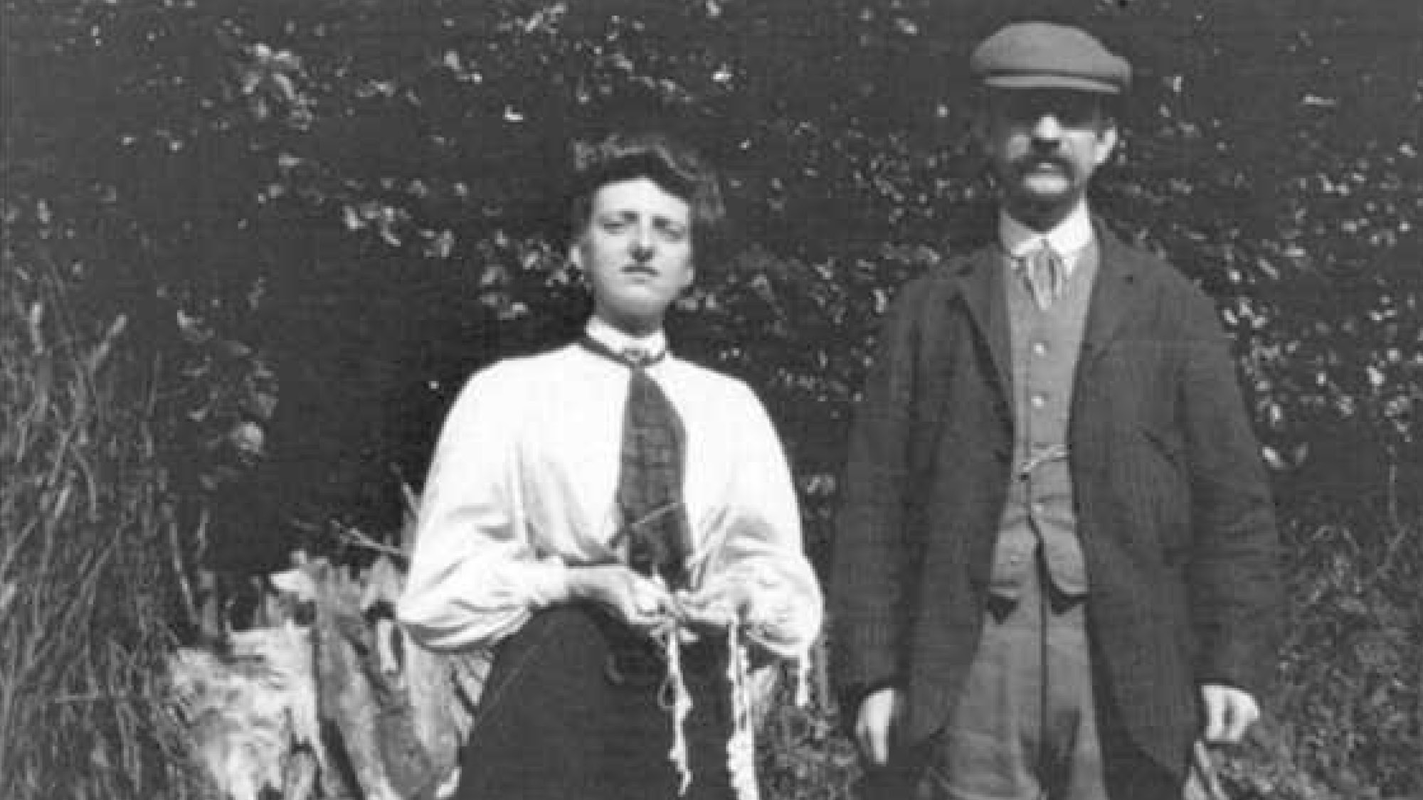 Historical photo of the Parish family: woman and man dressed formally, facing the camera, in rural outdoor setting